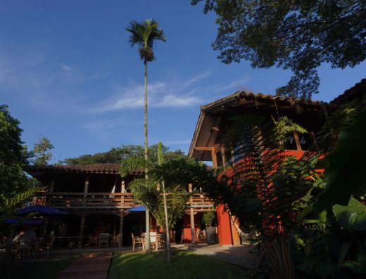 Vista aérea de Sazagua Hotel Boutique en Pereira con piscina azul, jardines tropicales, palmeras y edificios de arquitectura colonial